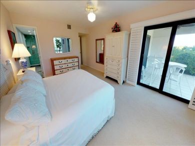Just Steps to the Sandy Beach from this Two Bedroom Condo